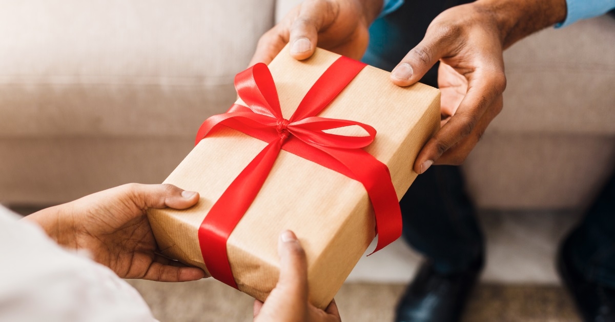 woman receiving packed gift from man