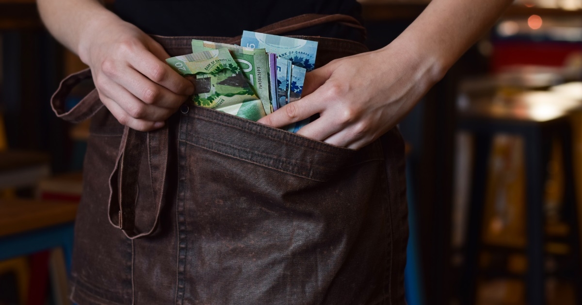 server keeping tips in apron pocket