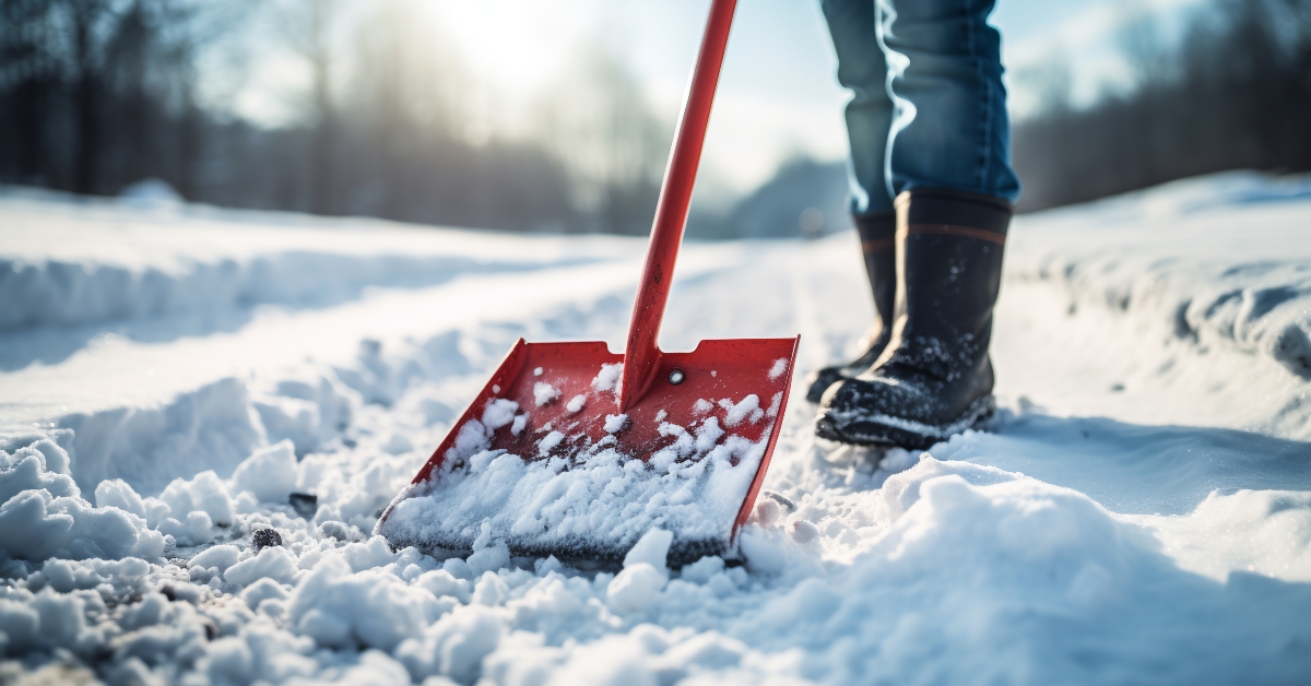 using a snow shovel to clear snow