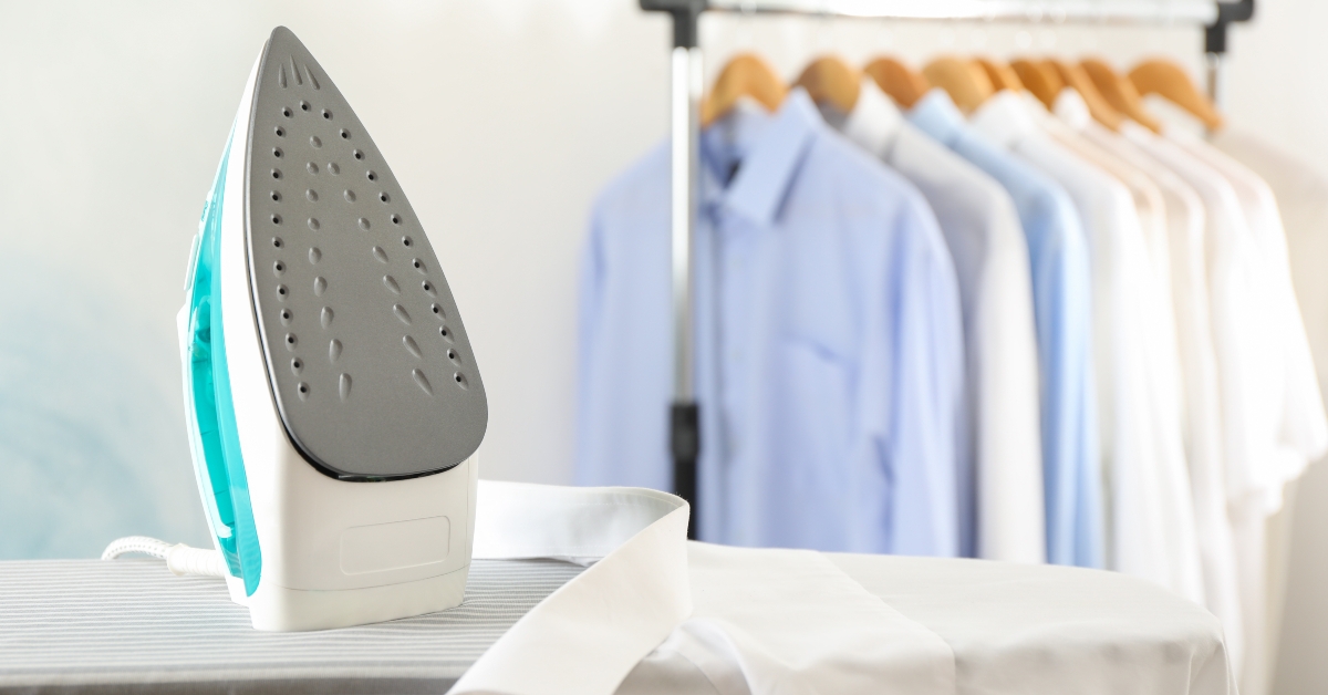 iron and shirt on ironing board