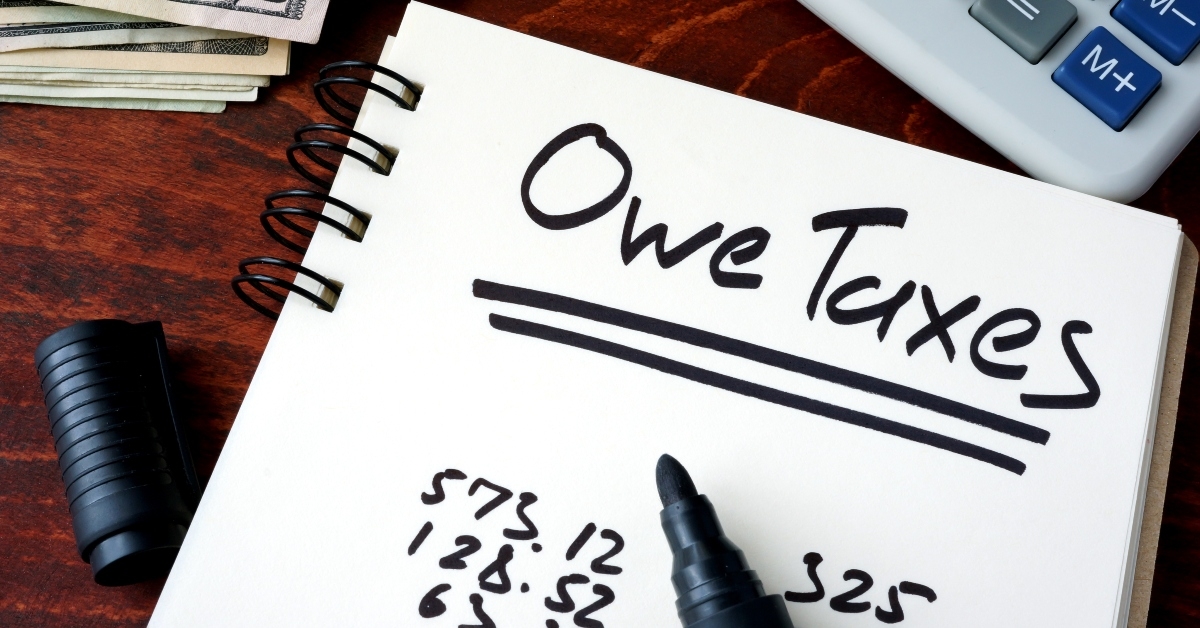 notepad with sign owe taxes