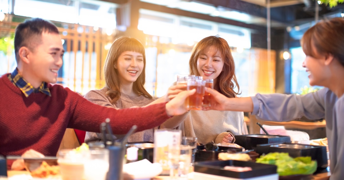 asian friends celebrating at restaurant