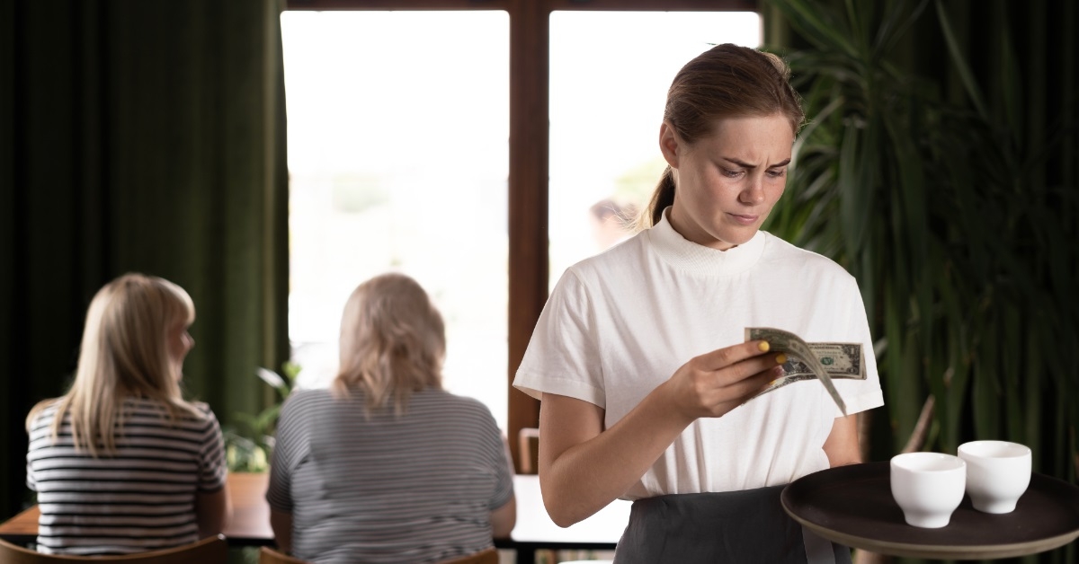 female waiter dissatisfied with tip