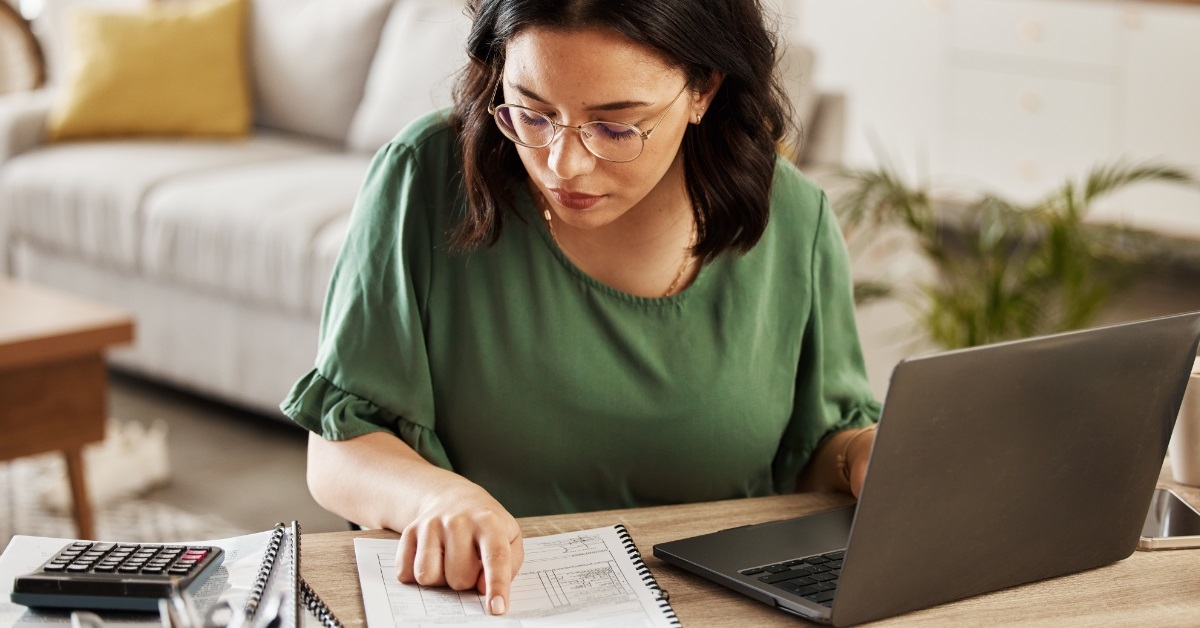 woman reviewing bills using laptop