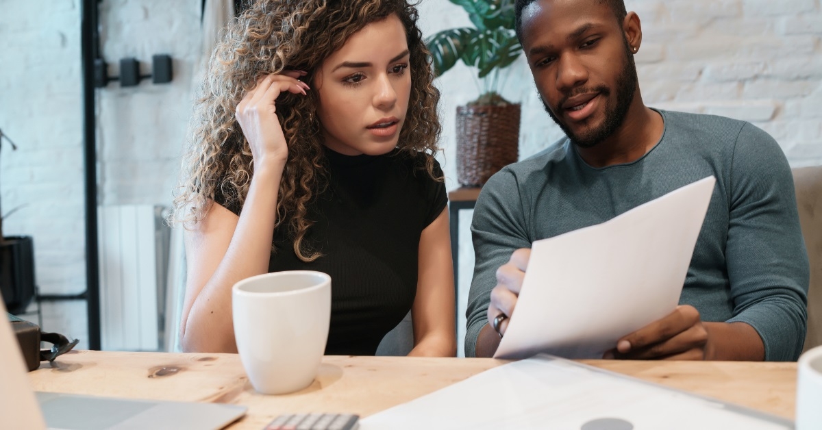 multi ethnic couple reviewing budget