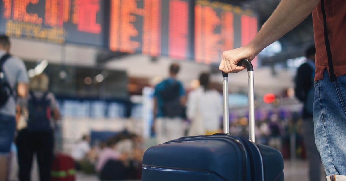 man waiting for flight at airport