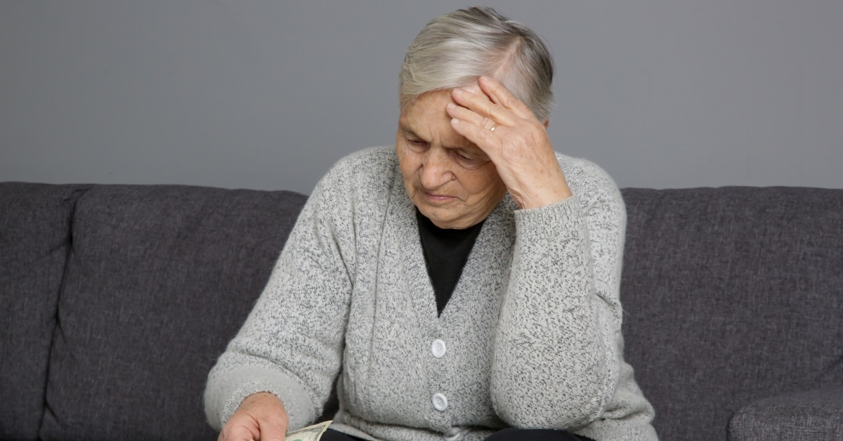 senior woman counting savings at home