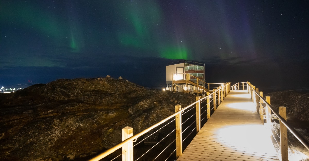 greenland coast village with aurora borealis
