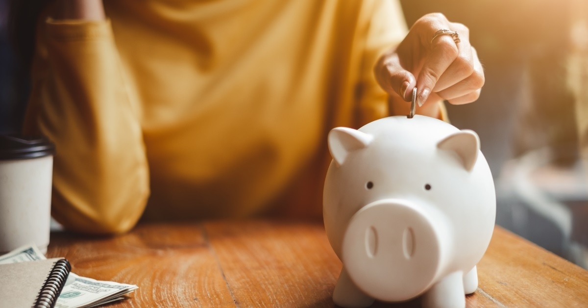 woman saving money in piggy bank