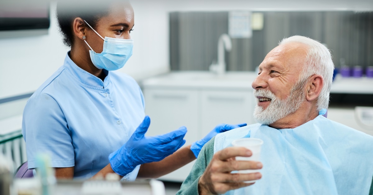 female dentist assistant assisting senior patient