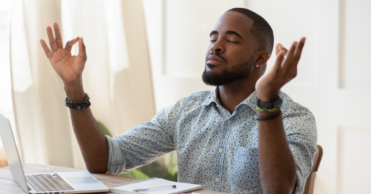 relaxed african american remote worker meditating