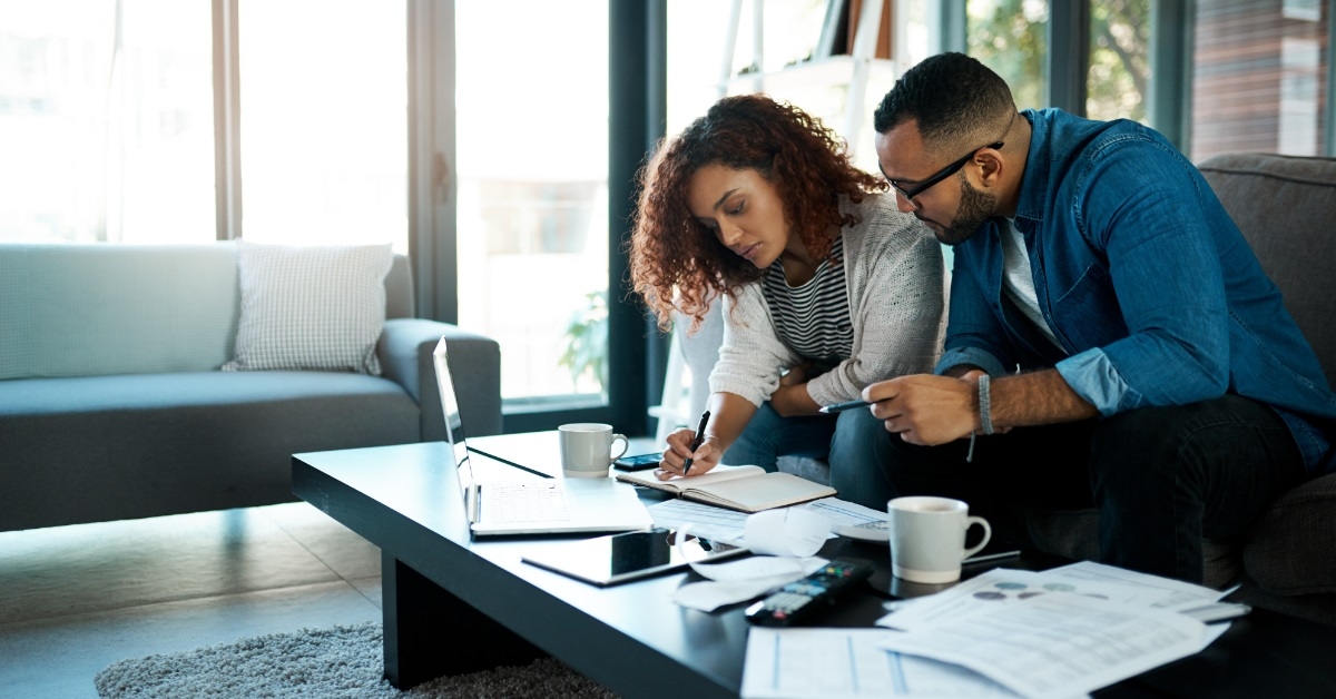 couple reviewing finances on couch