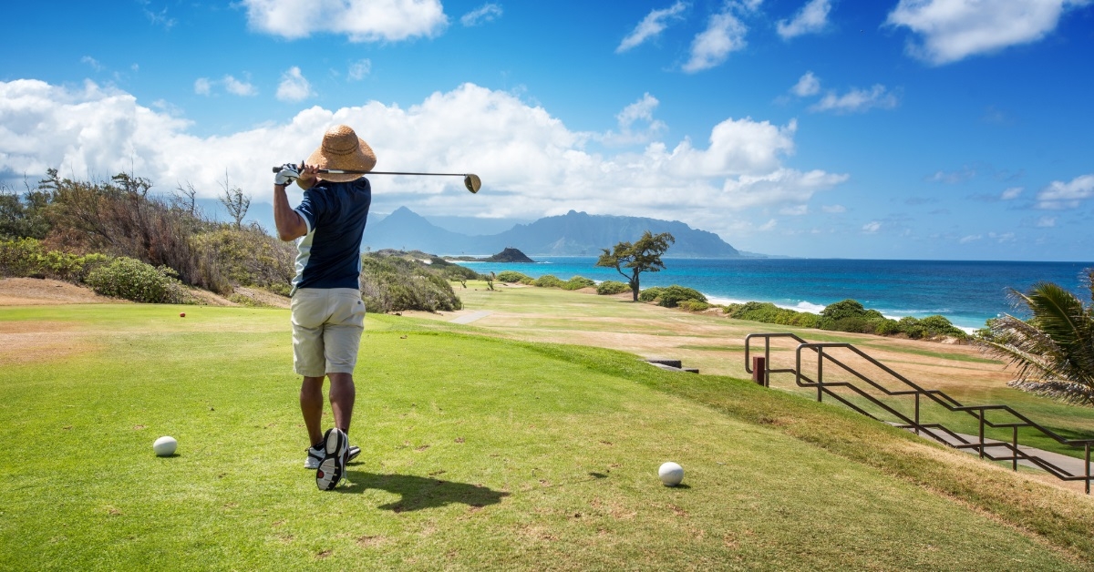 golfer wearing straw hat playing golf