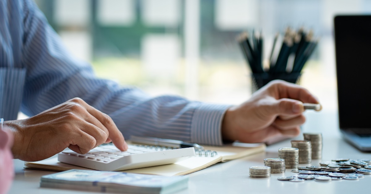 man dividing expenses on table
