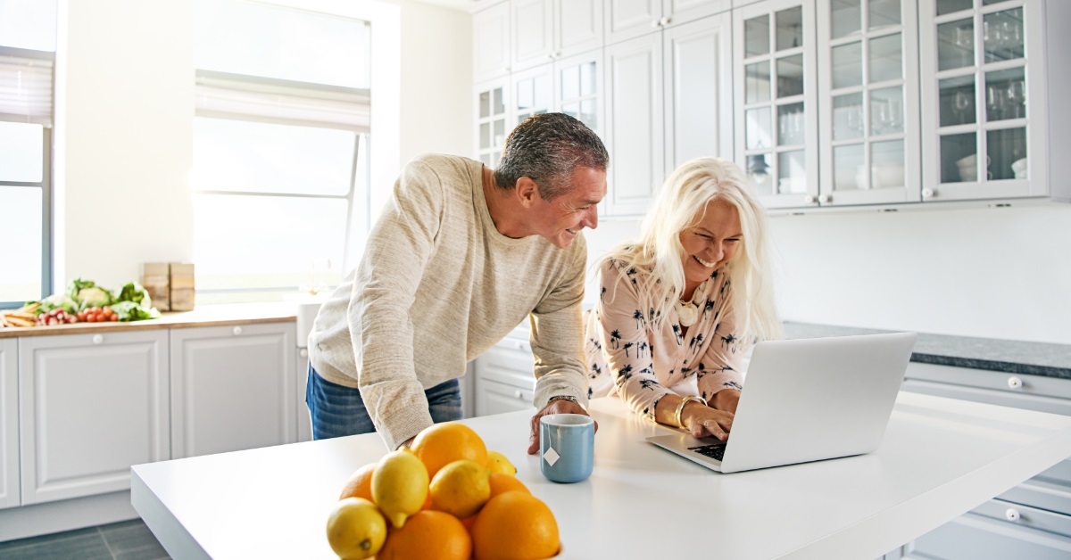 happy senior couple using laptop together