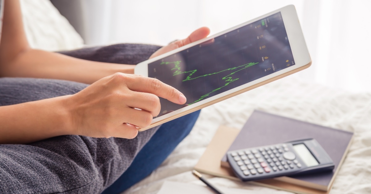 woman reviewing investment graph on tablet