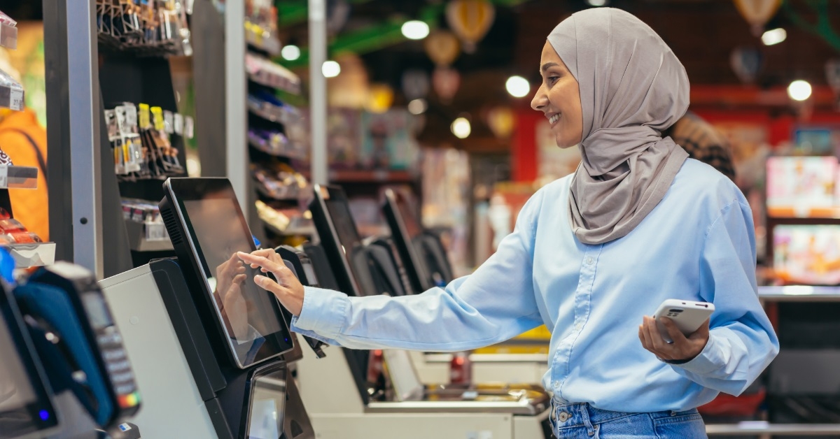 woman in hijab doing self checkout