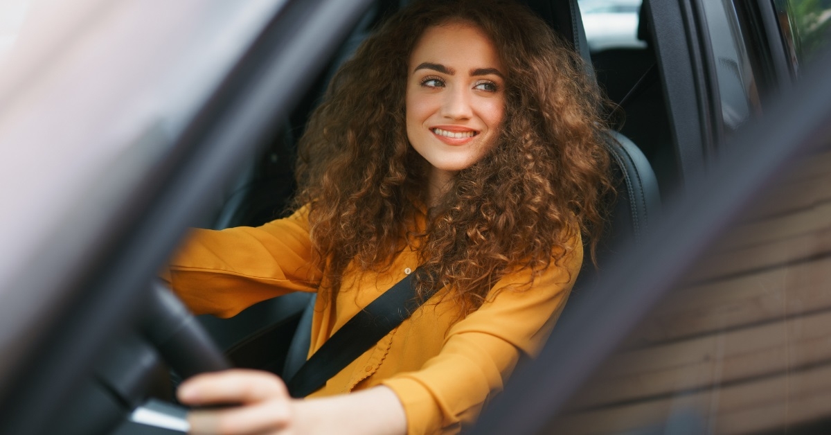 attractive woman sitting in driving seat