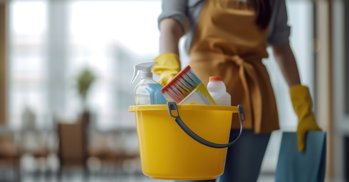woman standing with bucket and detergent