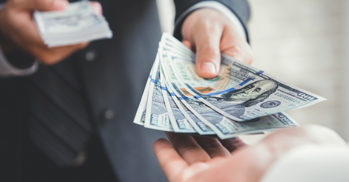 businessman giving or paying money