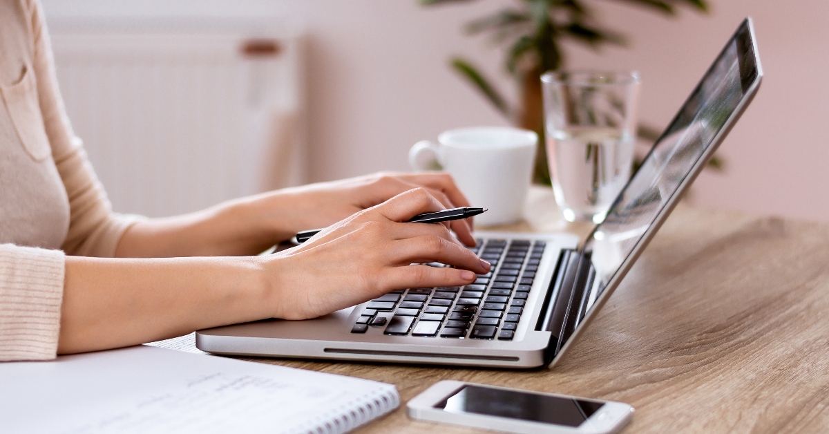 hands typing on laptop keyboard