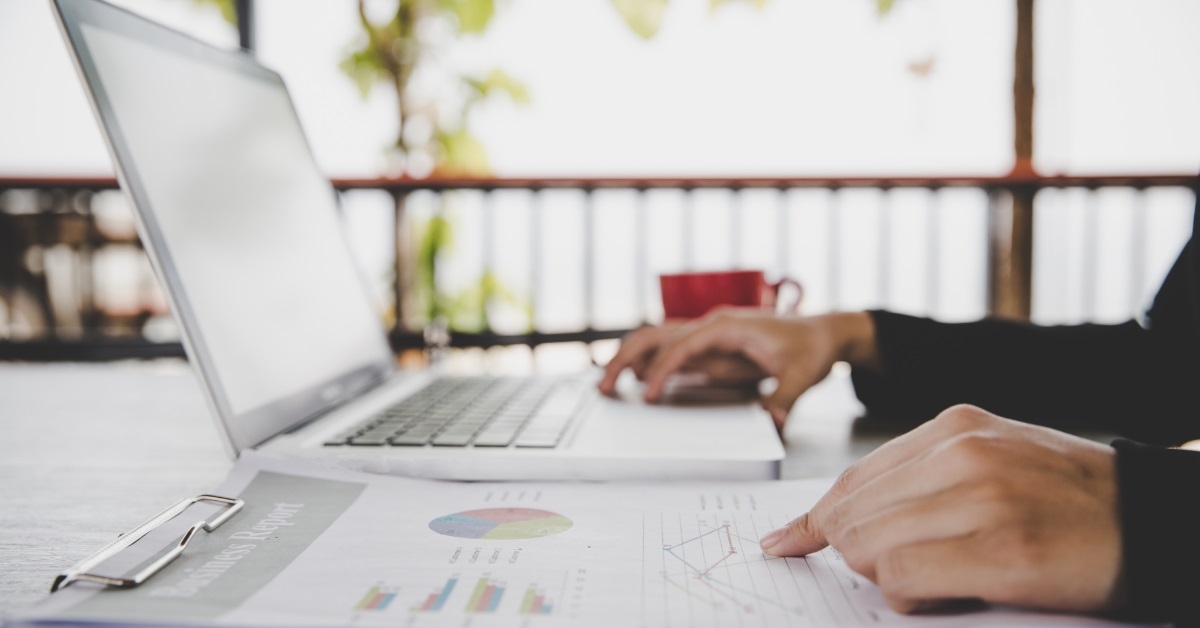 business woman reviewing data using laptop