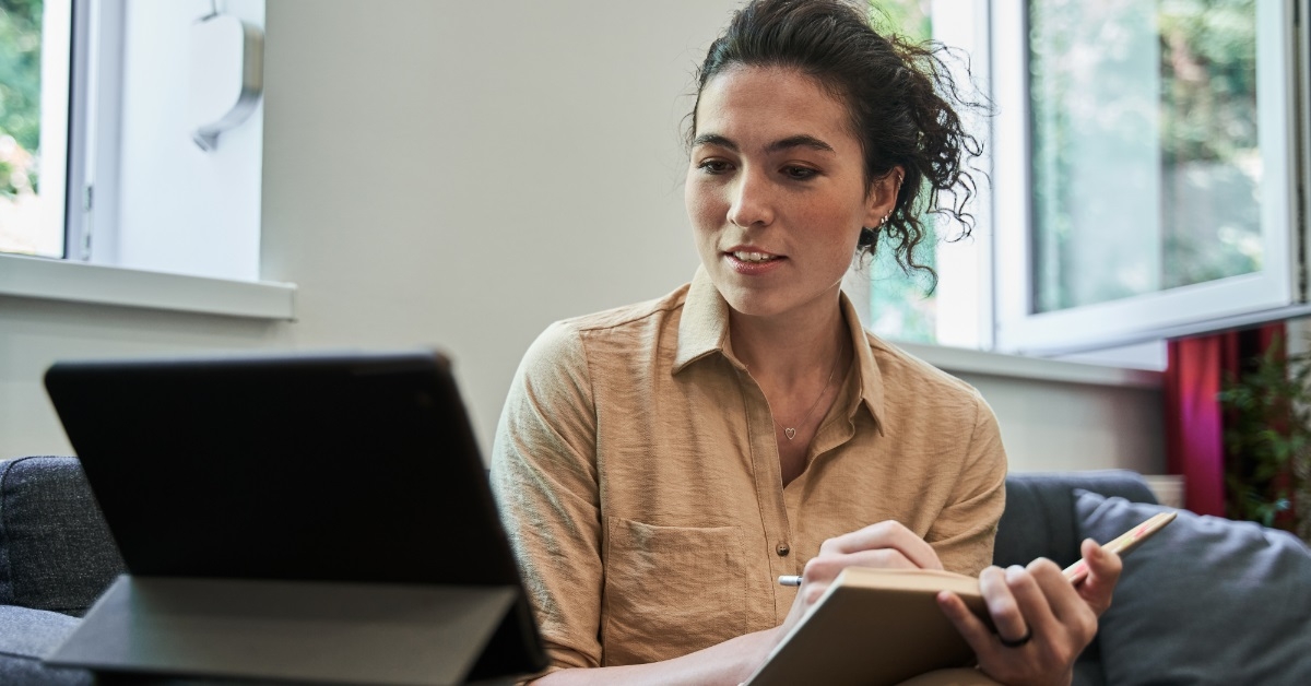female psychologist making notes during session