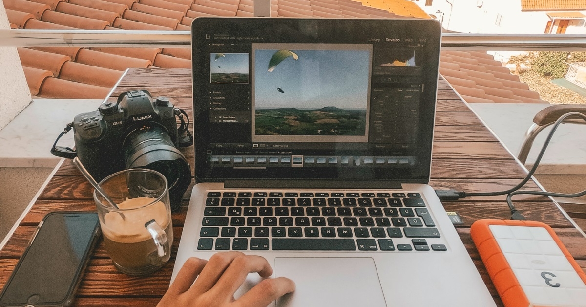 photographer using macbook on site