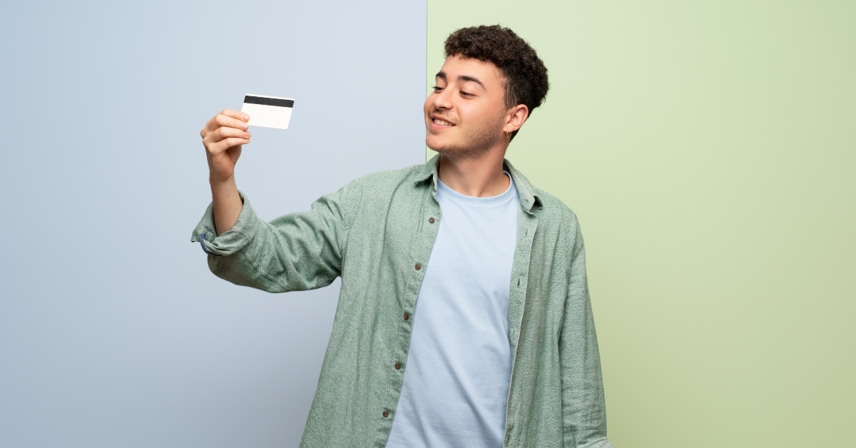 holding a credit card and thinking