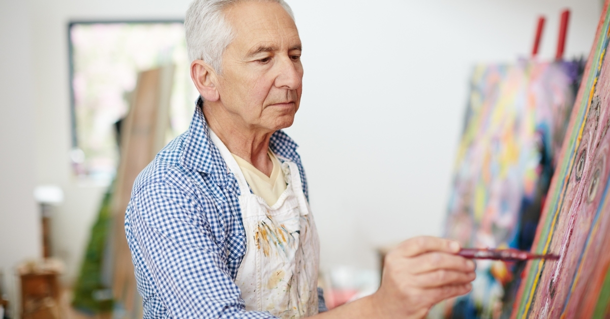 senior man working on a painting