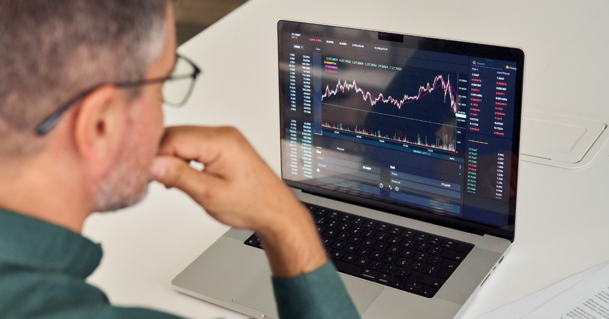 male investor reviewing crypto graphs