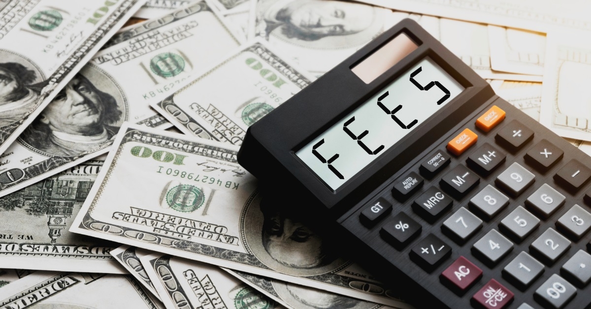 calculator displaying fees sign on money
