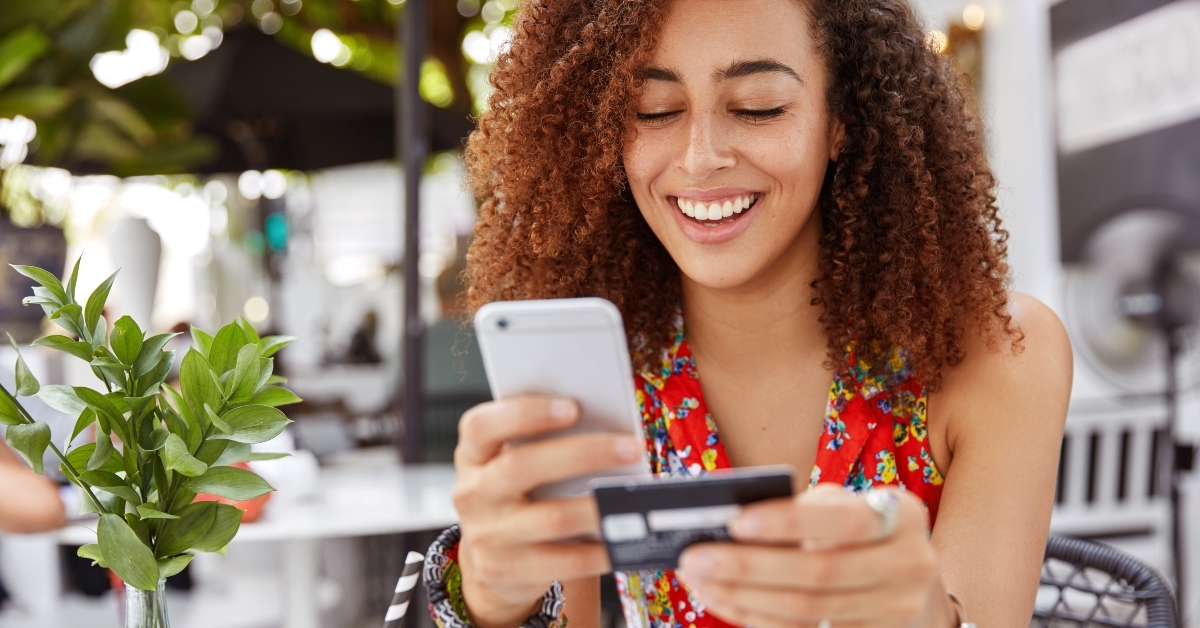 holds smart phone and credit card