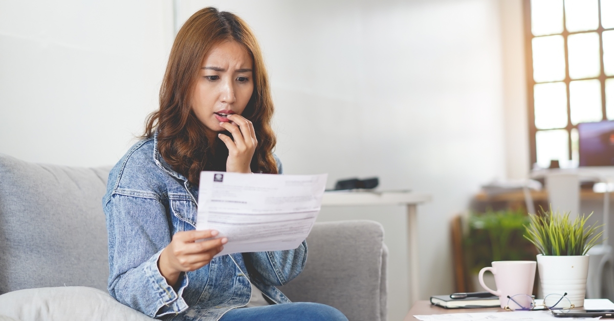 woman looking at monthly bill
