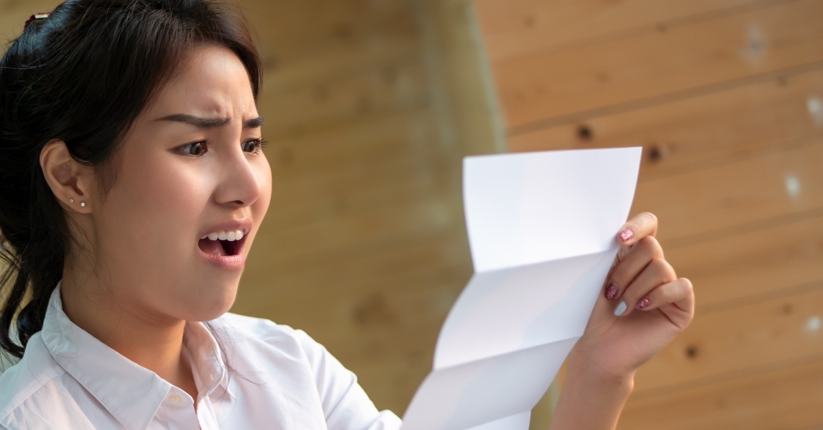 woman screaming at expensive bill