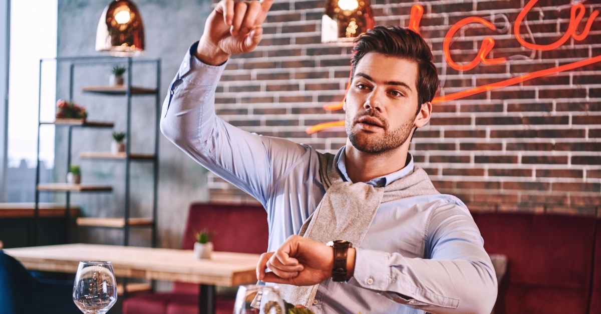 man calling waiter at restaurant