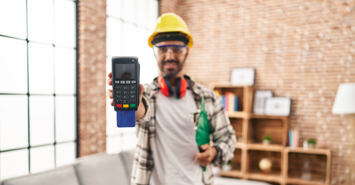 worker smiling holding a phone