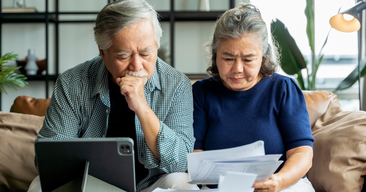 asian senior couple checking bills