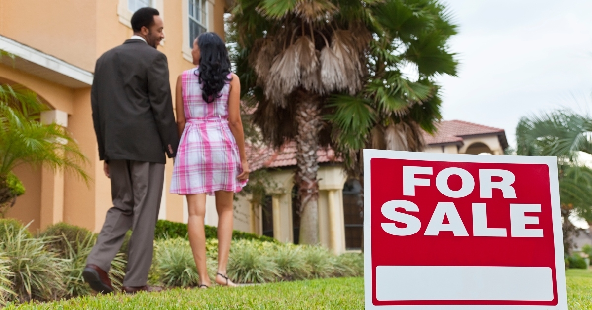 couple beside house for sale