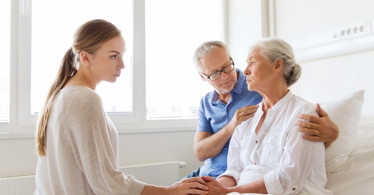 couple visiting senior patient at hospital