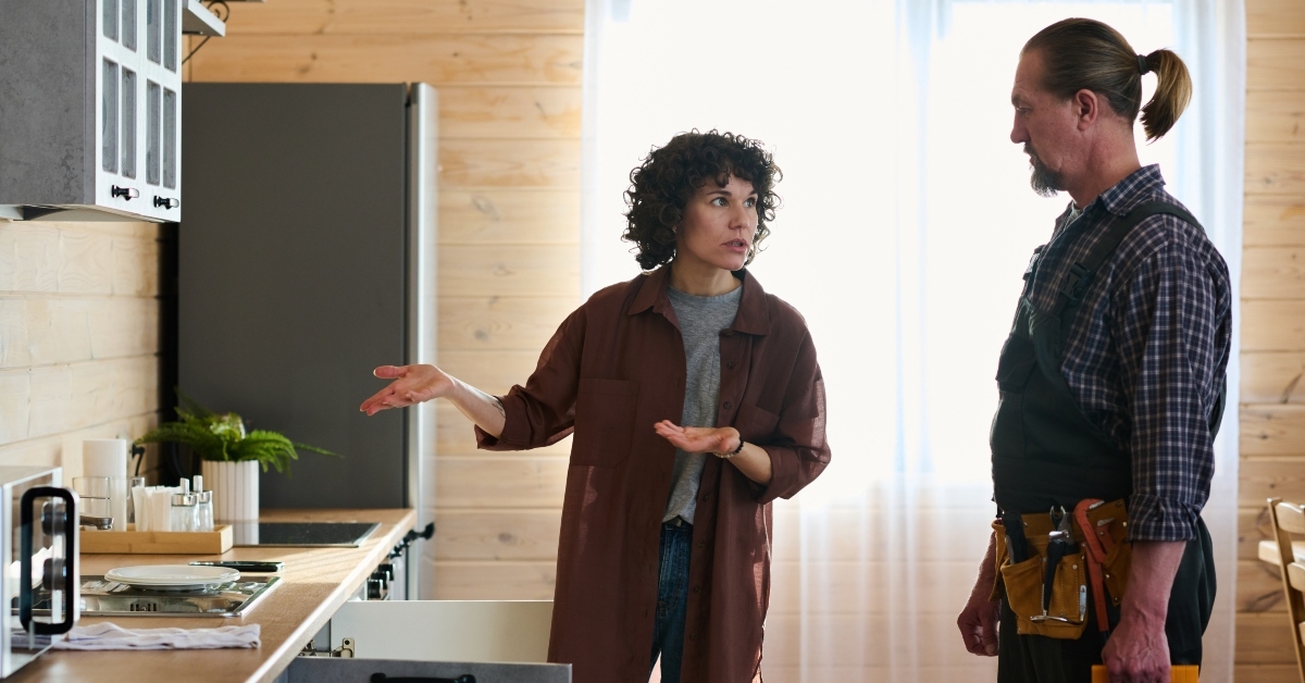 housewife looking at plumber