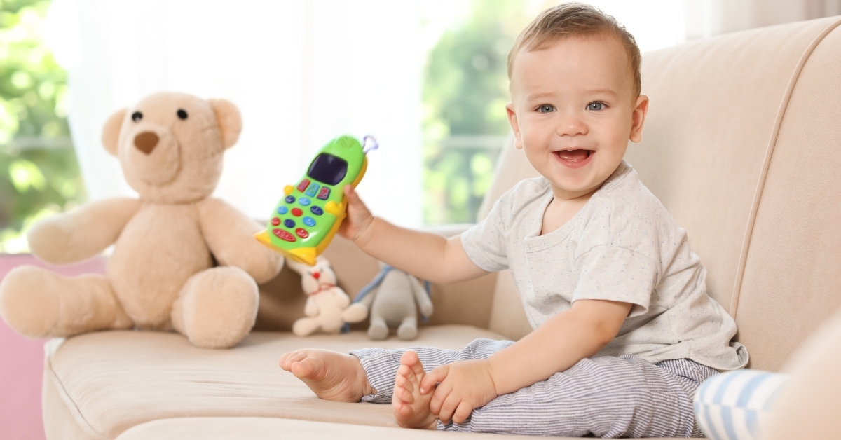 little baby with toy phone