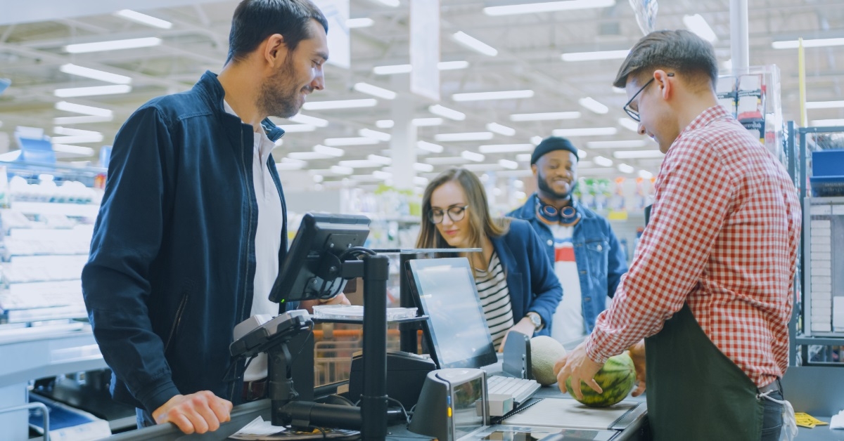 male cashier scanning groceries at store