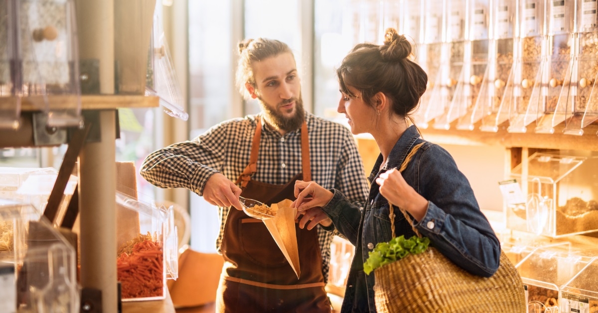 woman with salesman at food store