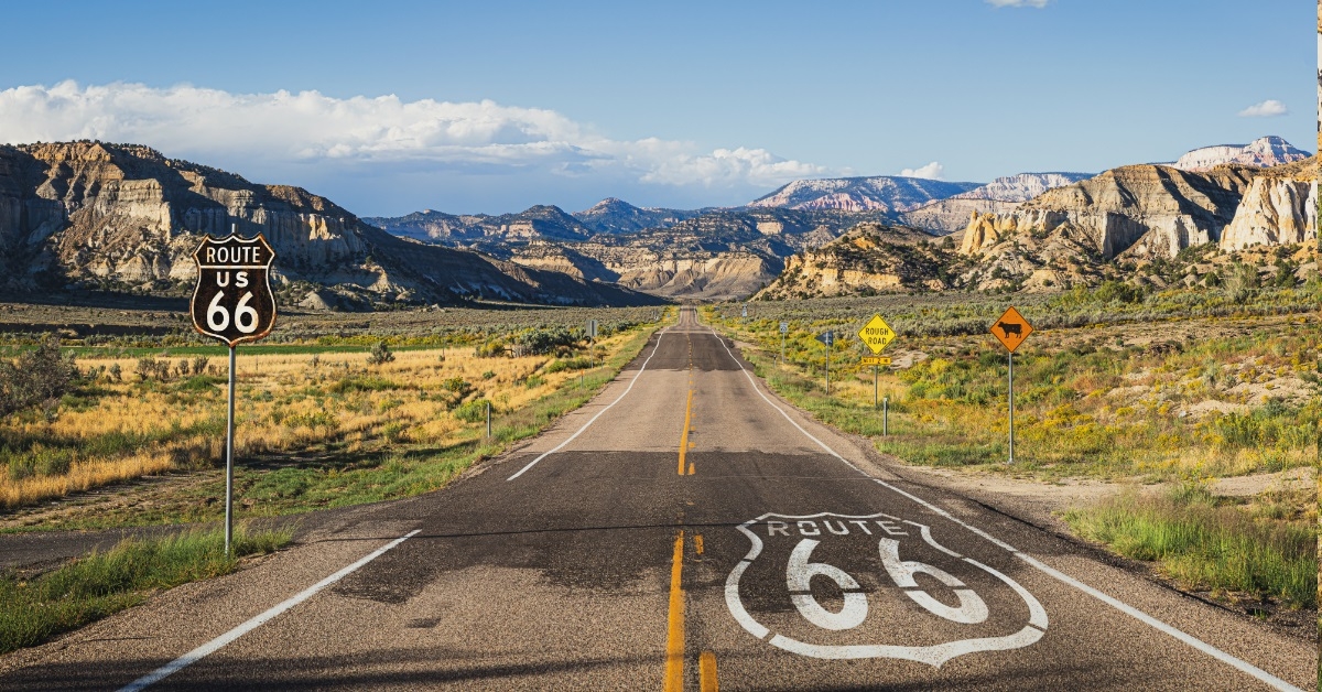 Route 66 with mountains at sunset