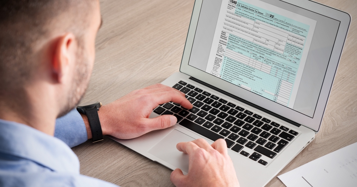 man filling tax form