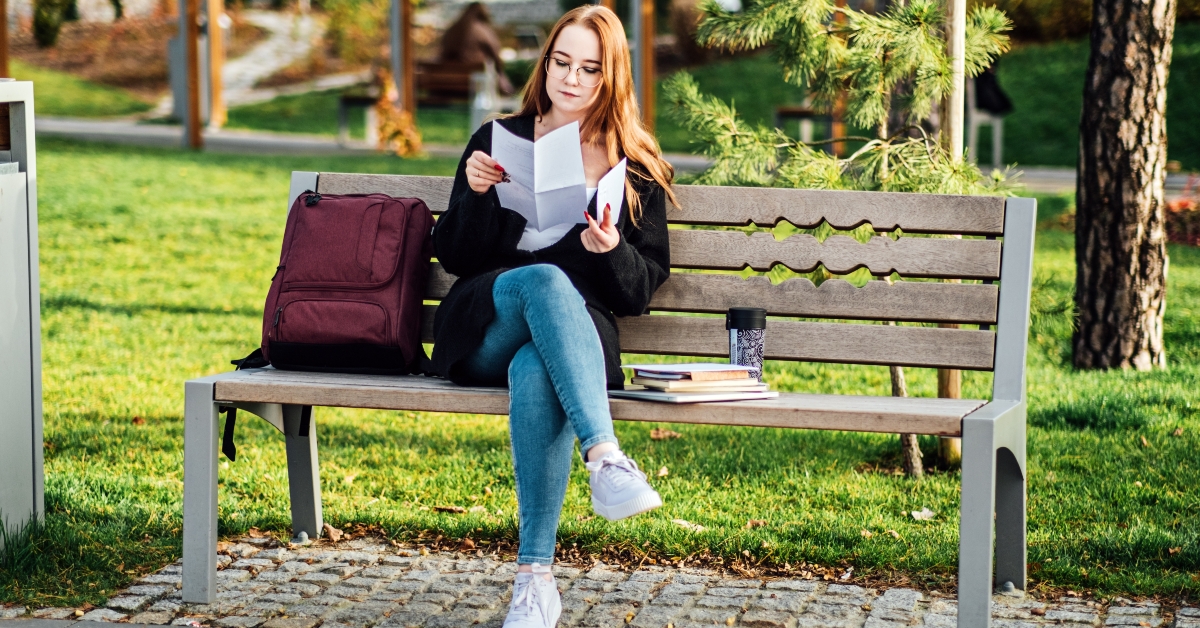 reading letter outdoors