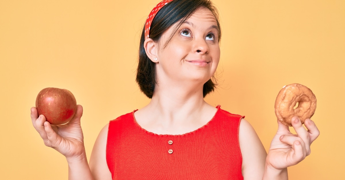 down syndrome woman holding apple donut