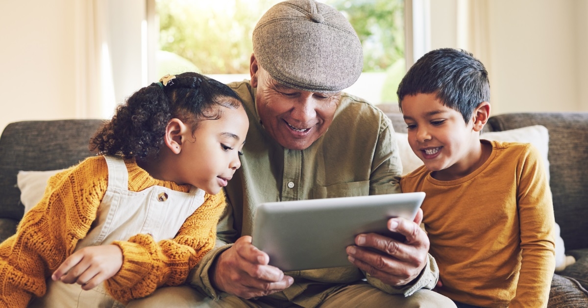 kids using tablet with grandparent