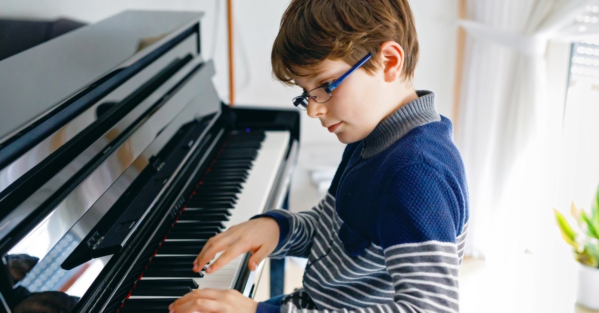 boy playing piano in living room